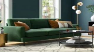 A modern living room with sofa, rug, lighting and coffee table