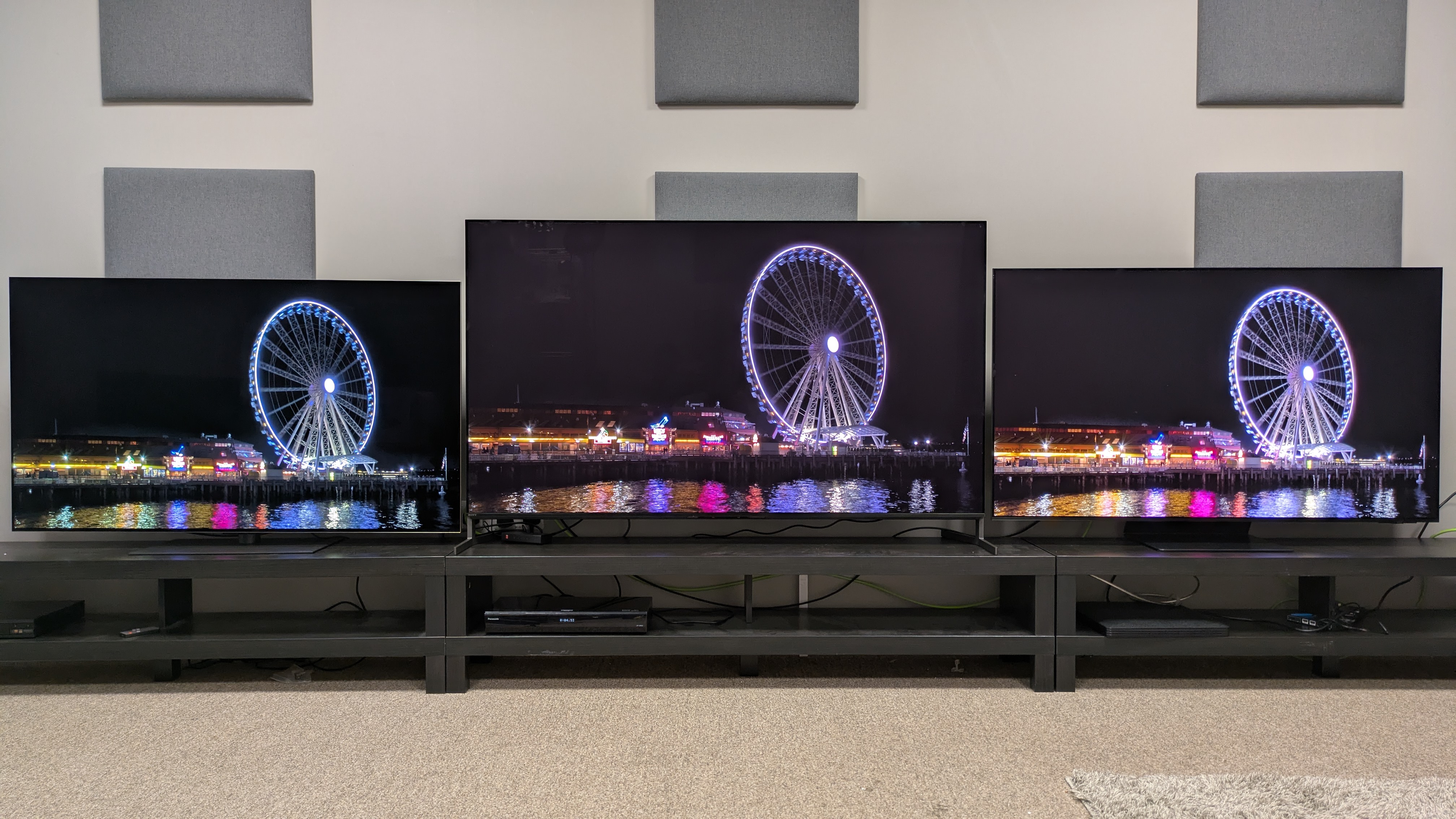 LG G5 (left), Sony Bravia 8 II (middle) and Samsung S95f (right) showing Ferris Wheel at night on screen