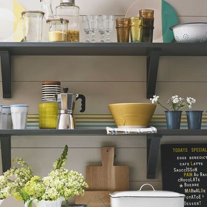 Wooden shelves with tins and glass