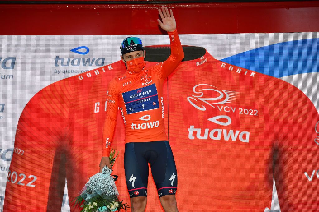 TORRENT SPAIN FEBRUARY 03 Remco Evenepoel of Belgium and Team QuickStep Alpha Vinyl Orange Points Jersey celebrates at podium after the during the 73rd Volta A La Comunitat Valenciana 2022 Stage 2 a 1715km stage from Btera to Torrent VCV2022 on February 03 2022 in Torrent Spain Photo by Dario BelingheriGetty Images