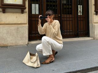 French fashion influencer Julie Sergent Ferreri wearing a chic fall sweater outfit in Paris.