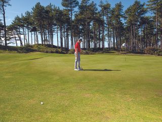 John Howells walking onto the green to work out his landing position for a chip shot