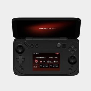 Ayaneo Flip DS handheld with shell flipped open and second screen set to utility mode with grey backdrop