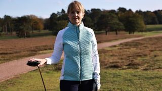 Golfer wearing Peter Millar Merge Mini Diamond Quilt Hybrid Jacket