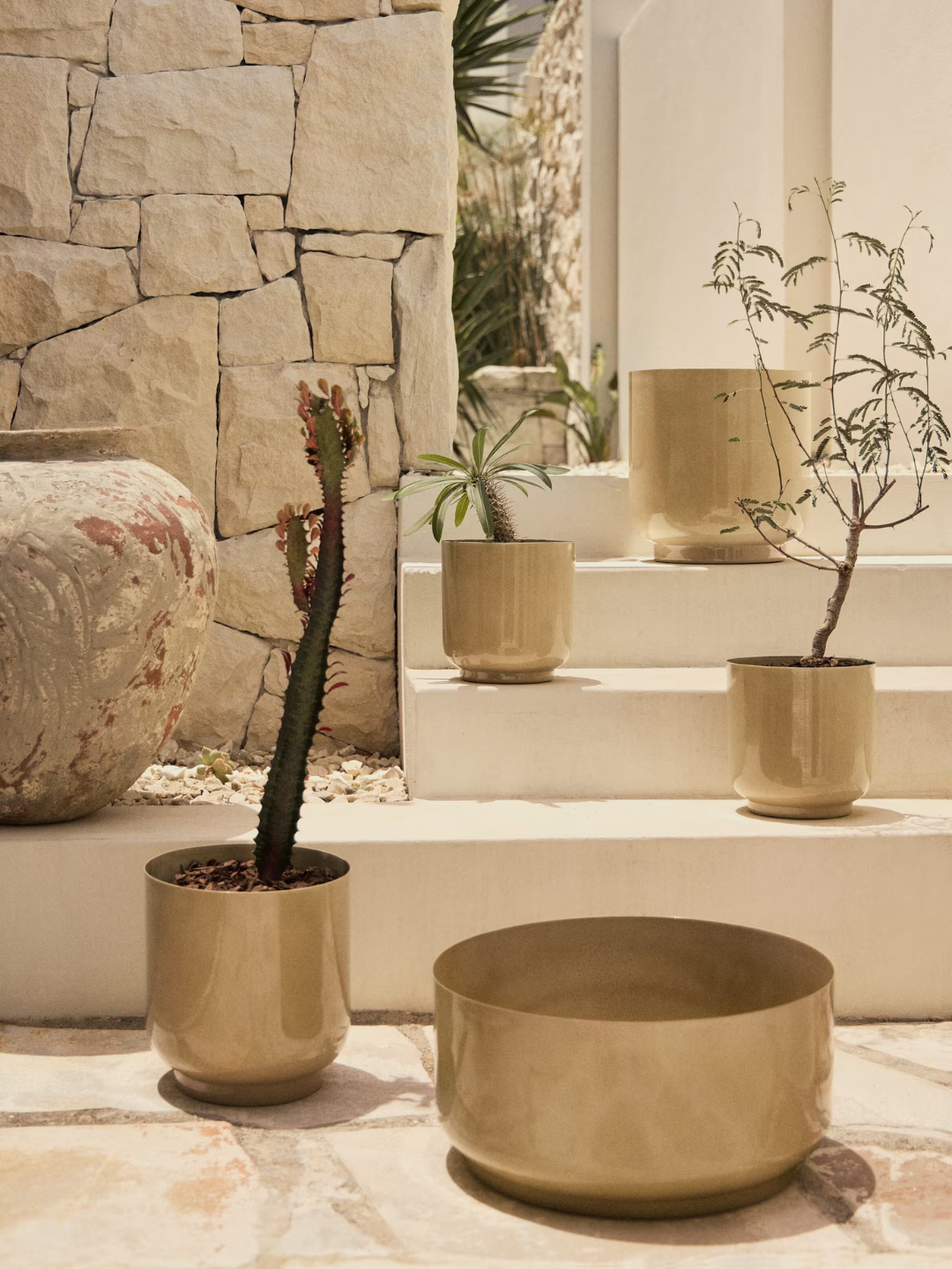 A set of butter yellow outdoor metal planters