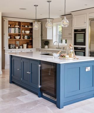 Two-tone kitchen cabinet with off white wall cabinets and a navy blue kitchen island