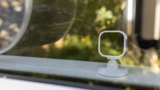 A Blink Mini behind a window bird feeder