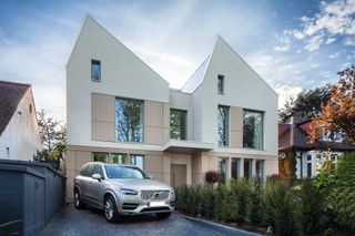 white rendered self build with double gable design and driveway
