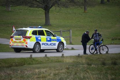 A police office talks to a member of the public in Richmond Park