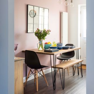 kitchen with pink coloured wall and flower pot on table