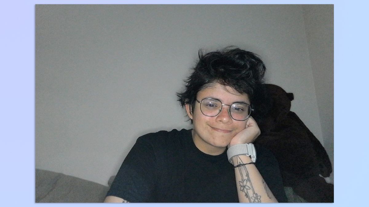 A photo of a person sitting on a couch, taken with a Razer Kiyo webcam (with ring light on full brightness)