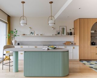 Pastel kitchen with concrete countertop and green island