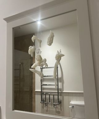 Shaving foam on a mirror with a white wooden border