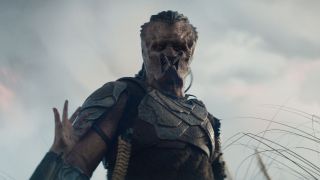 Thia reaches for Dek in Predator: Badlands