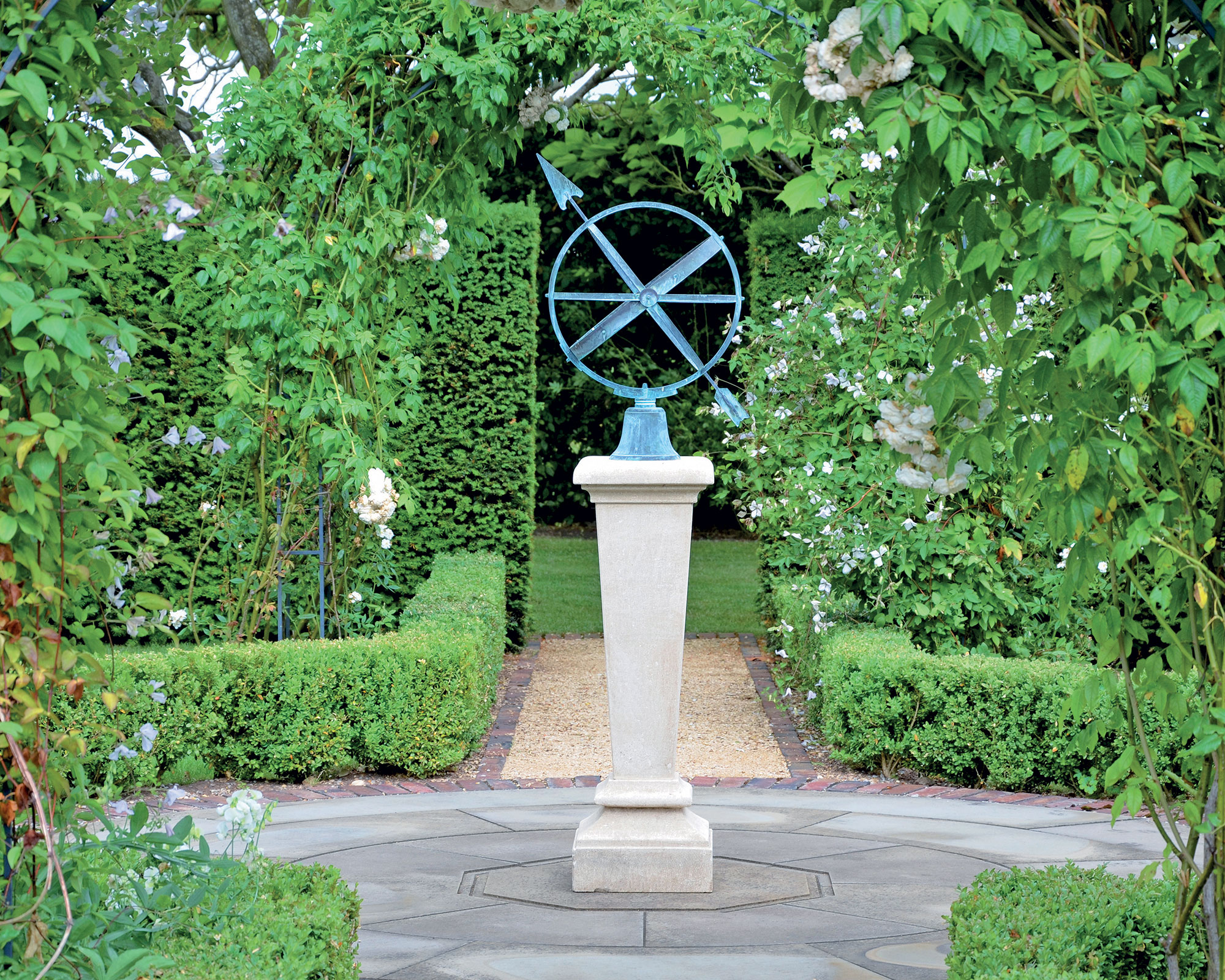 formal paved patio with statue in the center