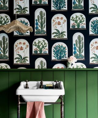 Green painted bathroom with green paneling and botanical wallpaper, natural low hanging pendant