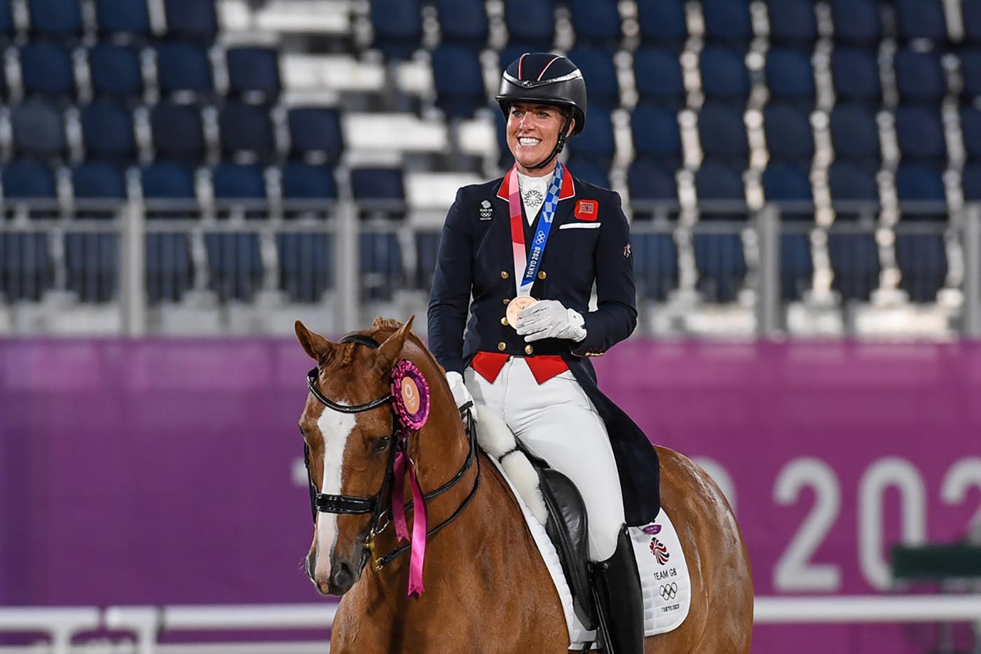 A delighted Charlotte Dujarding wears her Olympic bronze medal onboard Gio in the Tokyo individual dressage medal ceremony