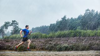 Man running in heavy rain