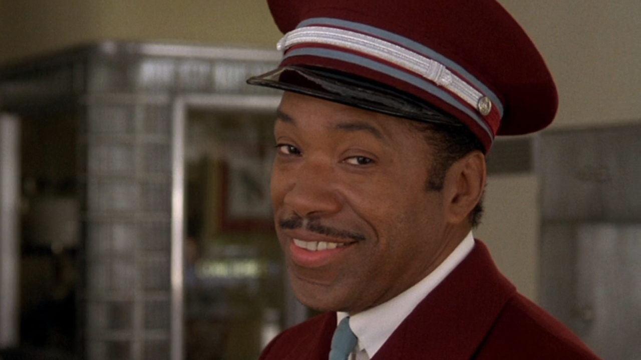 Obba Babatundé smiles knowingly at the camera in That Thing You Do!