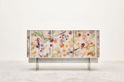 Detail of the Flora cabinet by Marcin Rusak with dried flowers embedded in a white resin surface