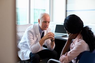 Doctor speaking with a patient.