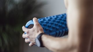 A person holding a foam roller