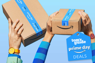 Arms holding aloft Amazon parcels on a blue background
