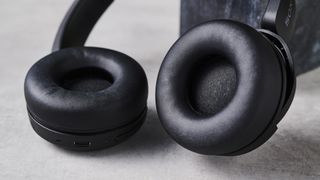 A photo of the Sony WH-CH520 over ear headphones resting against a black marble block