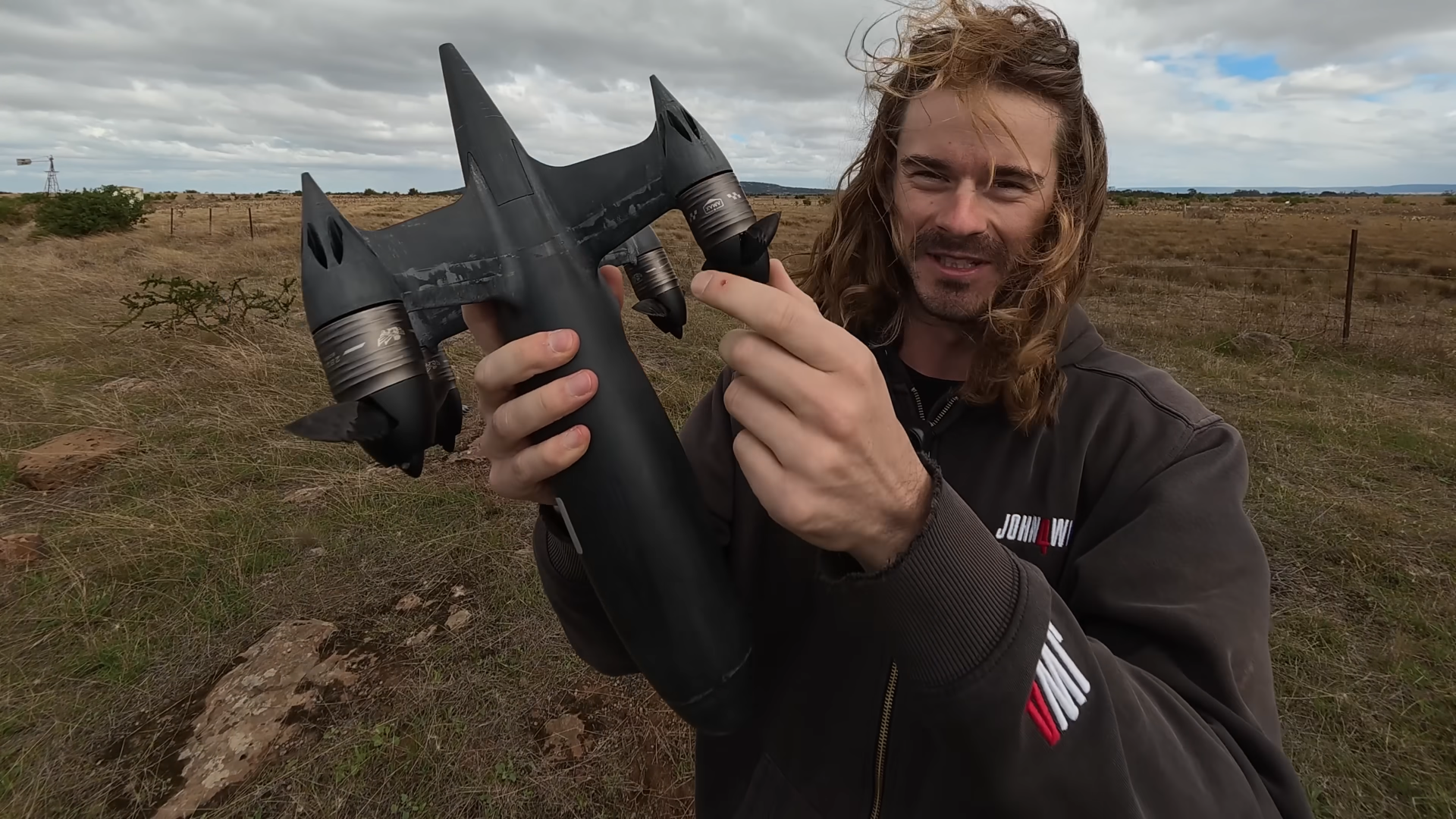 Ben Biggs holding his custom 'Blackbird' drone