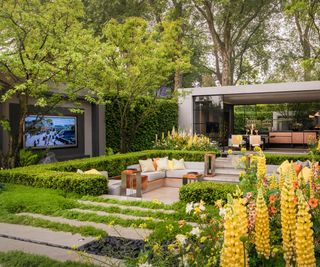 Huge beautiful backyard with flowers, sunken seating area, outdoor tv and backyard office