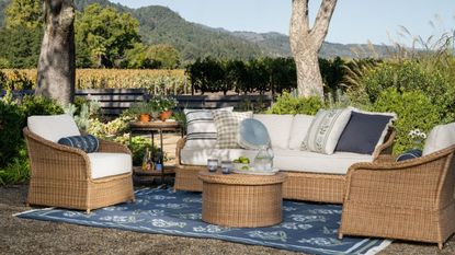 Natural wicker seating and patterned layers styled for the mcgee and co outdoor summer collection for 2026