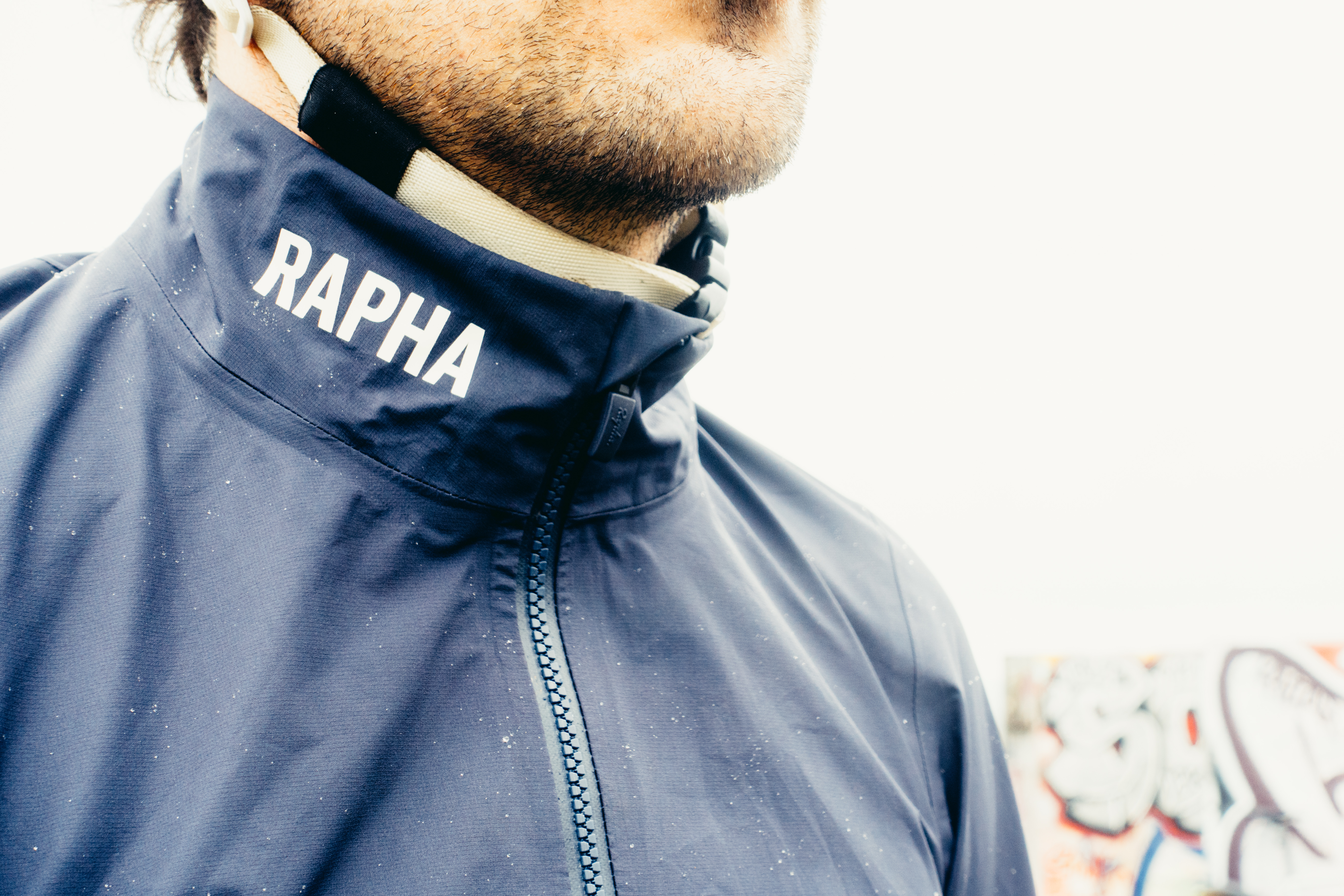 A close up of the collar of a blue waterproof cycling jacket