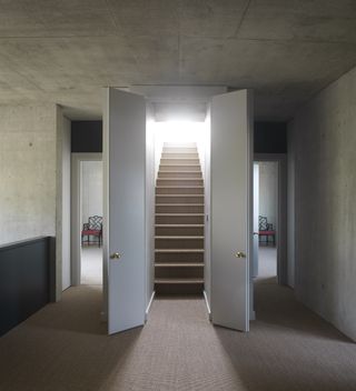 A staircase with a door on either side of it.