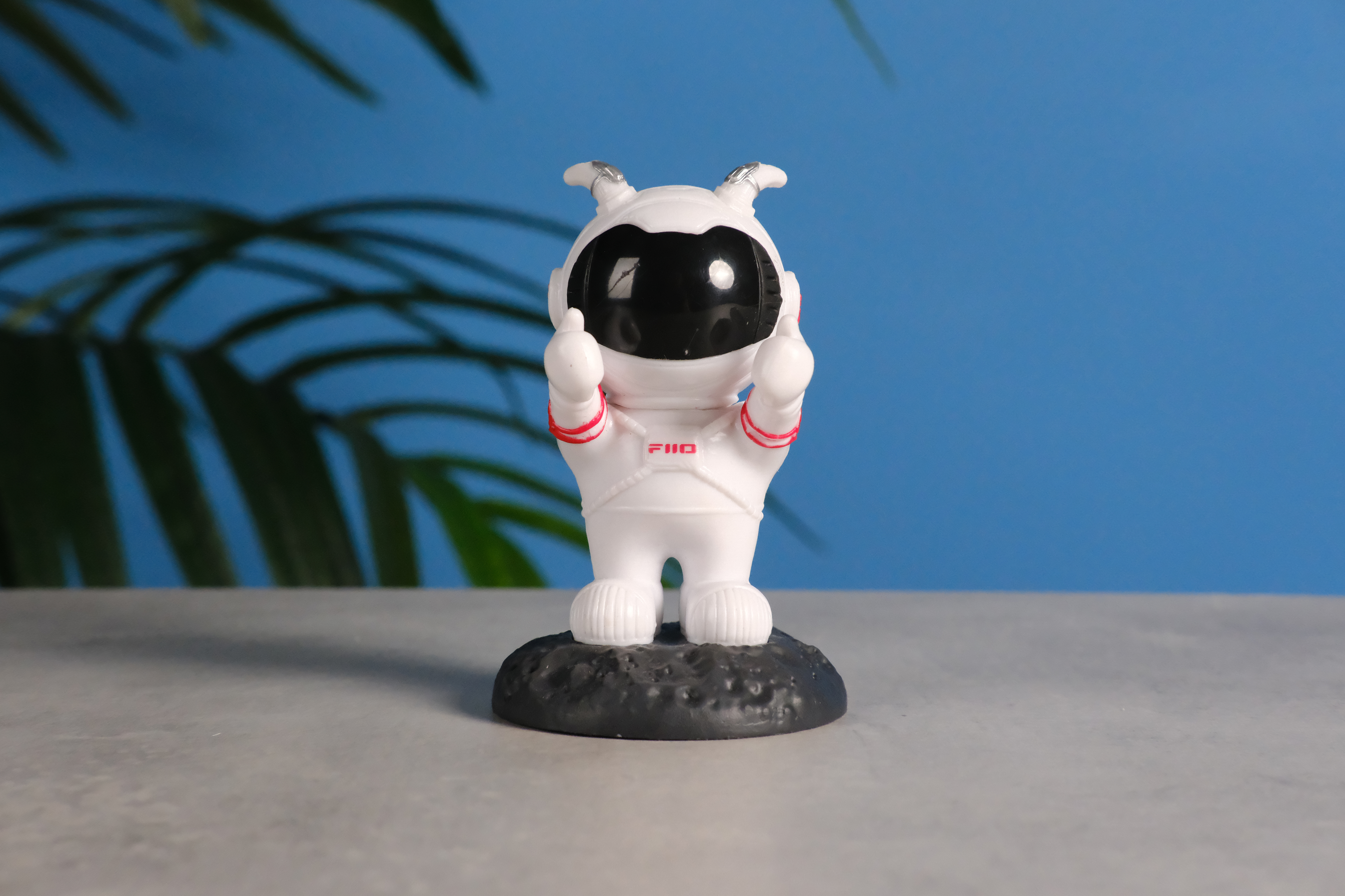 A photo of an astronaut toy against a blue background, taken on the Fujifilm X-E5