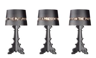 Block capital letters on the lampshade of his matte black Bourgie