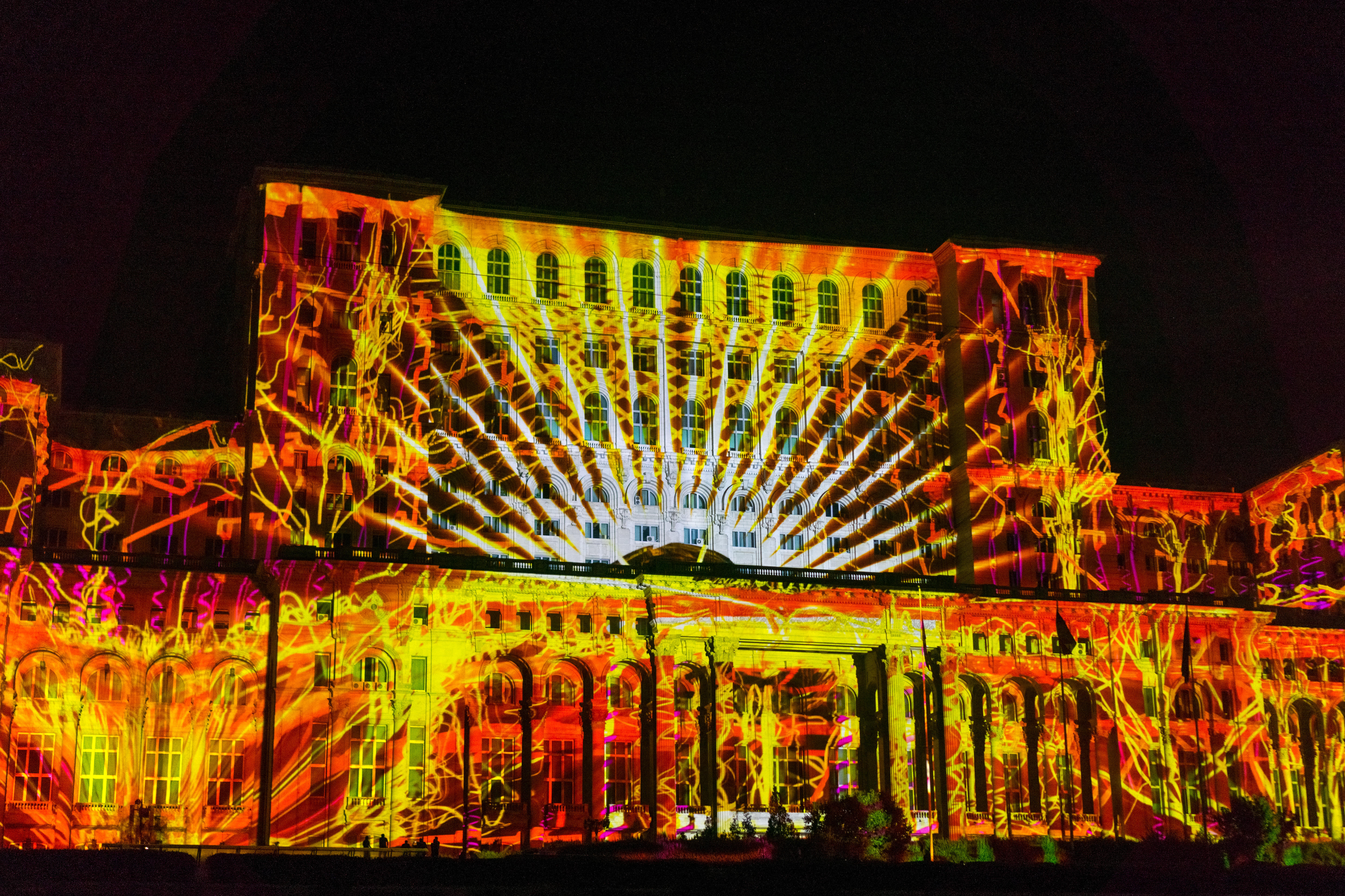 The facade of the romanian parliament is lit up in beautiful lights