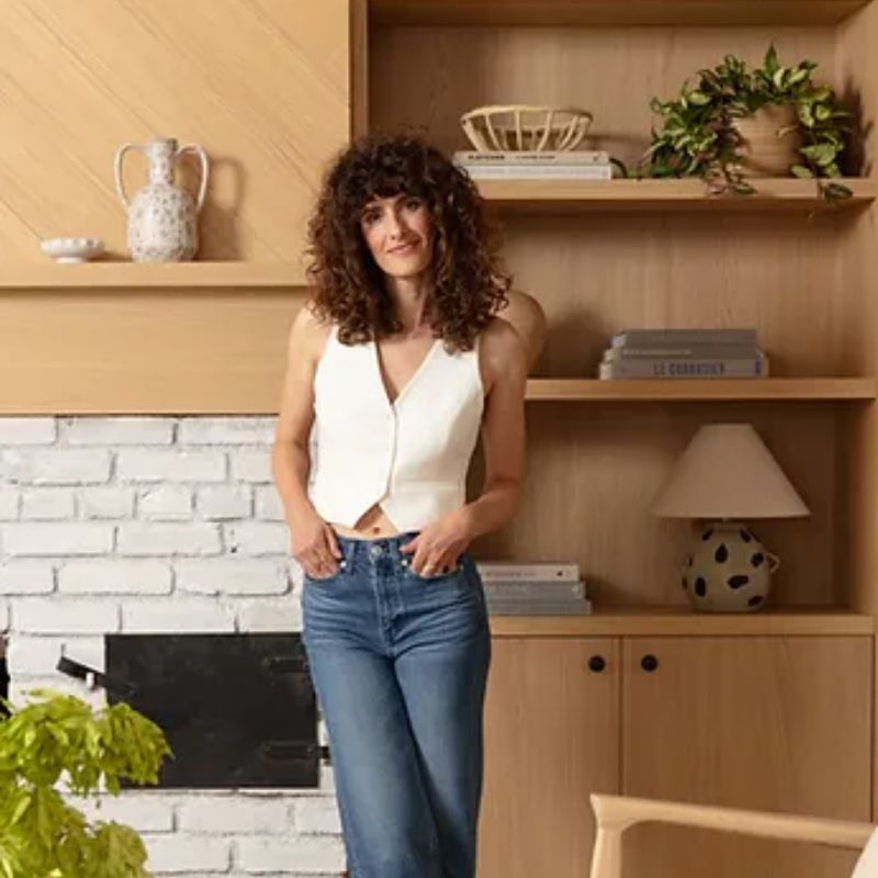 Kara Piepmeyer in neutral living space with wooden shelves