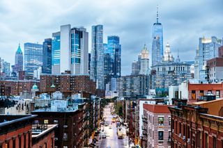 Manhattan's Financial District skyscrapers as seen from Chinatown on a rainy and cloudy day