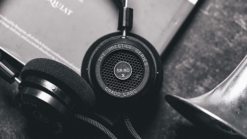 Grado SR80x black on-ear headphones in black on a book
