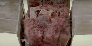 A human skull inside a box that's buried in human flesh in an utterly disgusting shot on Bones.