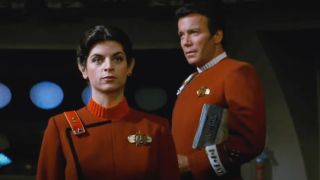 Kirstie Alley stands in front of William Shatner as he gives her feedback in Star Trek II: The Wrath of Khan.