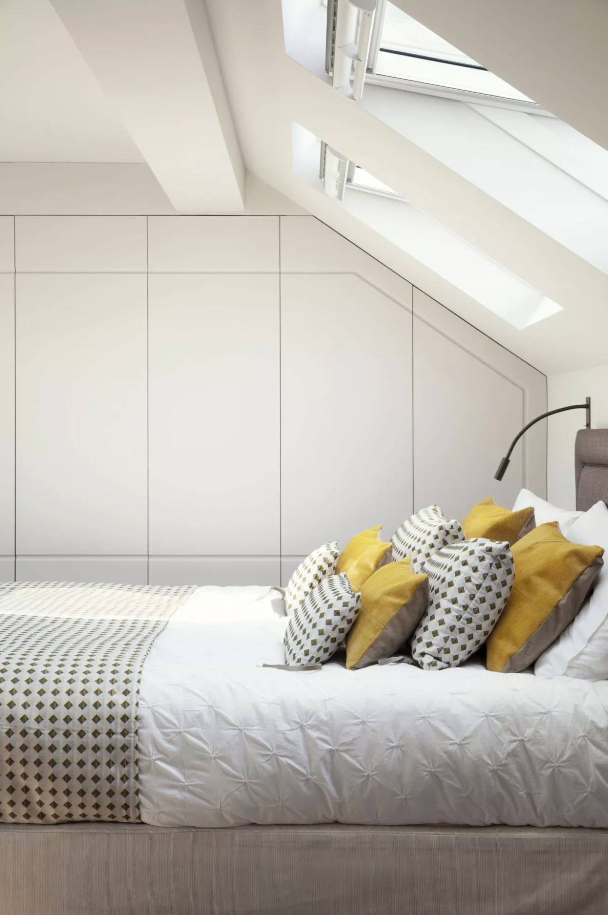 Loft bedroom with built in storage under the eaves