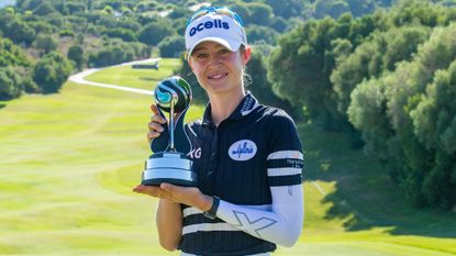 Nelly Korda poses with the trophy after winning the individual competition in the 2022 Aramco Team Series Sotogrande event 
