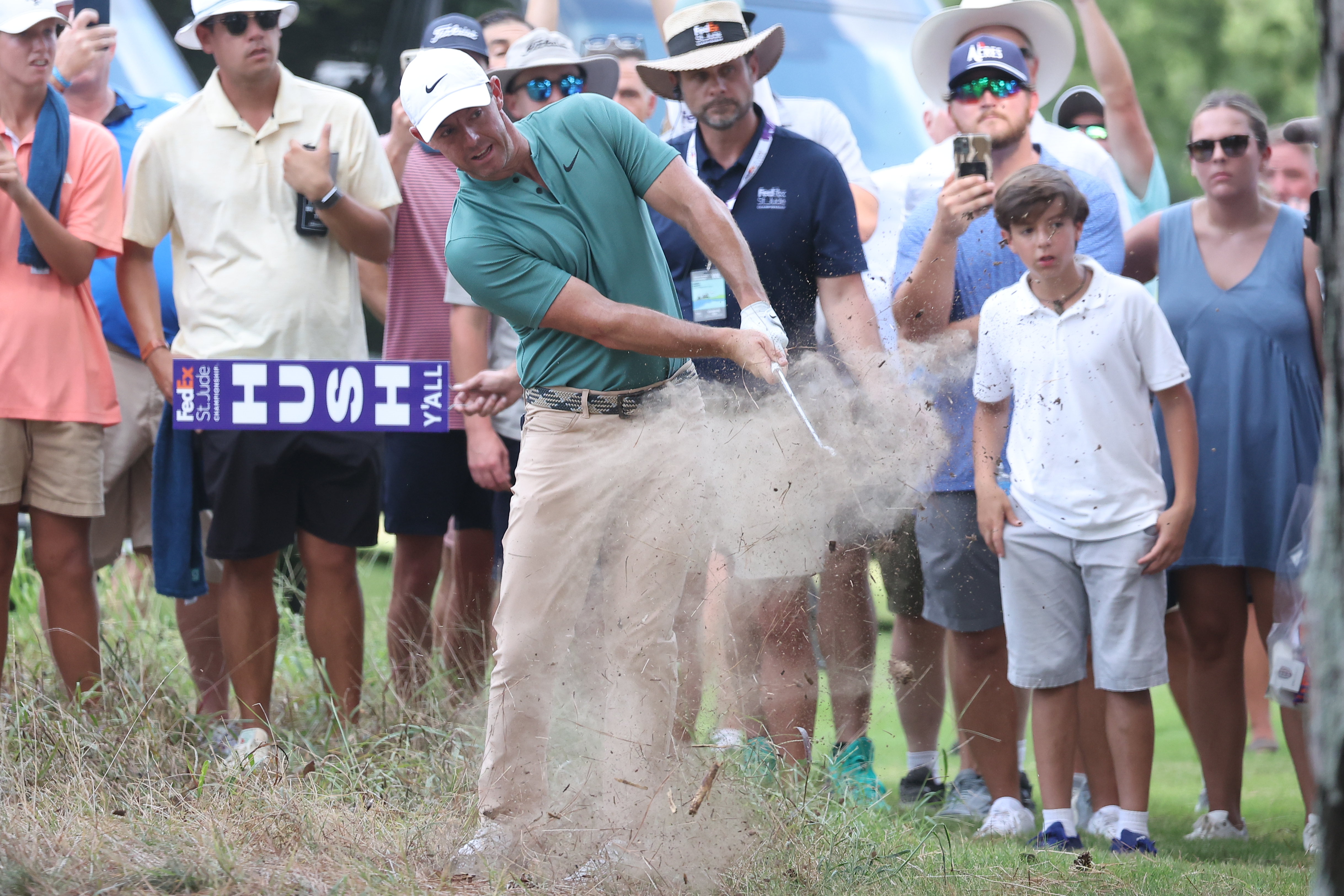 Rory McIlroy hits a wedge shot from dirt