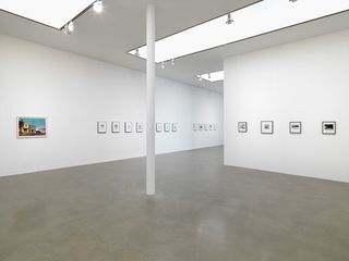 A view of the installation in the gallery showing pictures on walls