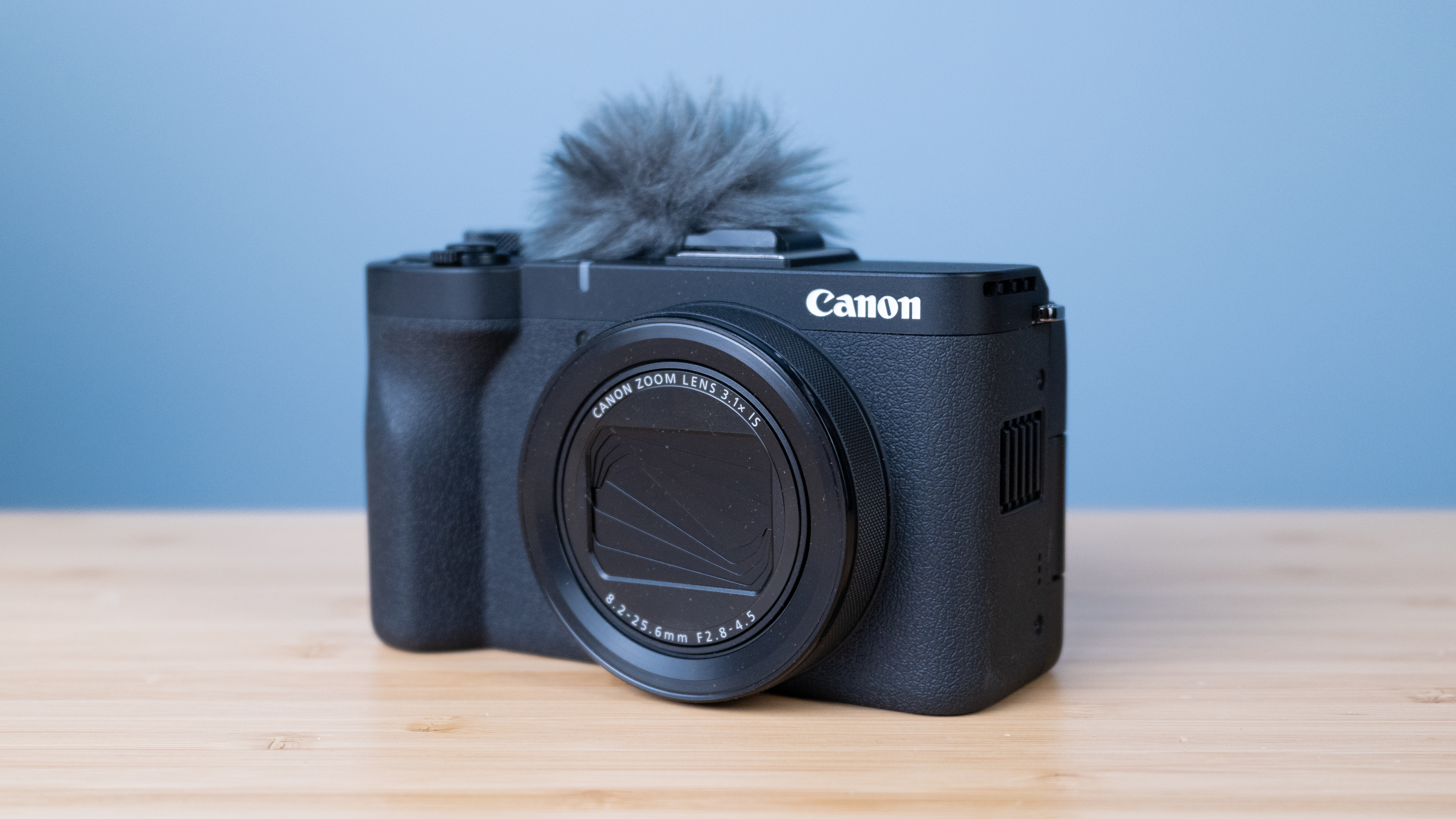 A black Canon PowerShot V1 compact vlogging camera