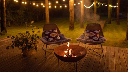 fire pit on decking with festoon lights
