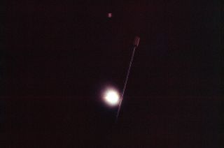 The first total solar eclipse seen from space, as photographed by Gemini 12 crewmates Jim Lovell and Buzz Aldrin on Nov. 12, 1966. The boom seen in the foreground is the antenna on an Agena target vehicle docked to the Gemini spacecraft.