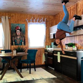 upside down kitchen with wooden wall and dining table