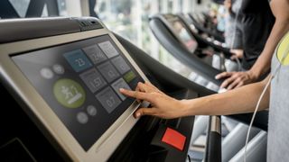 Woman using touchscreen treadmill display
